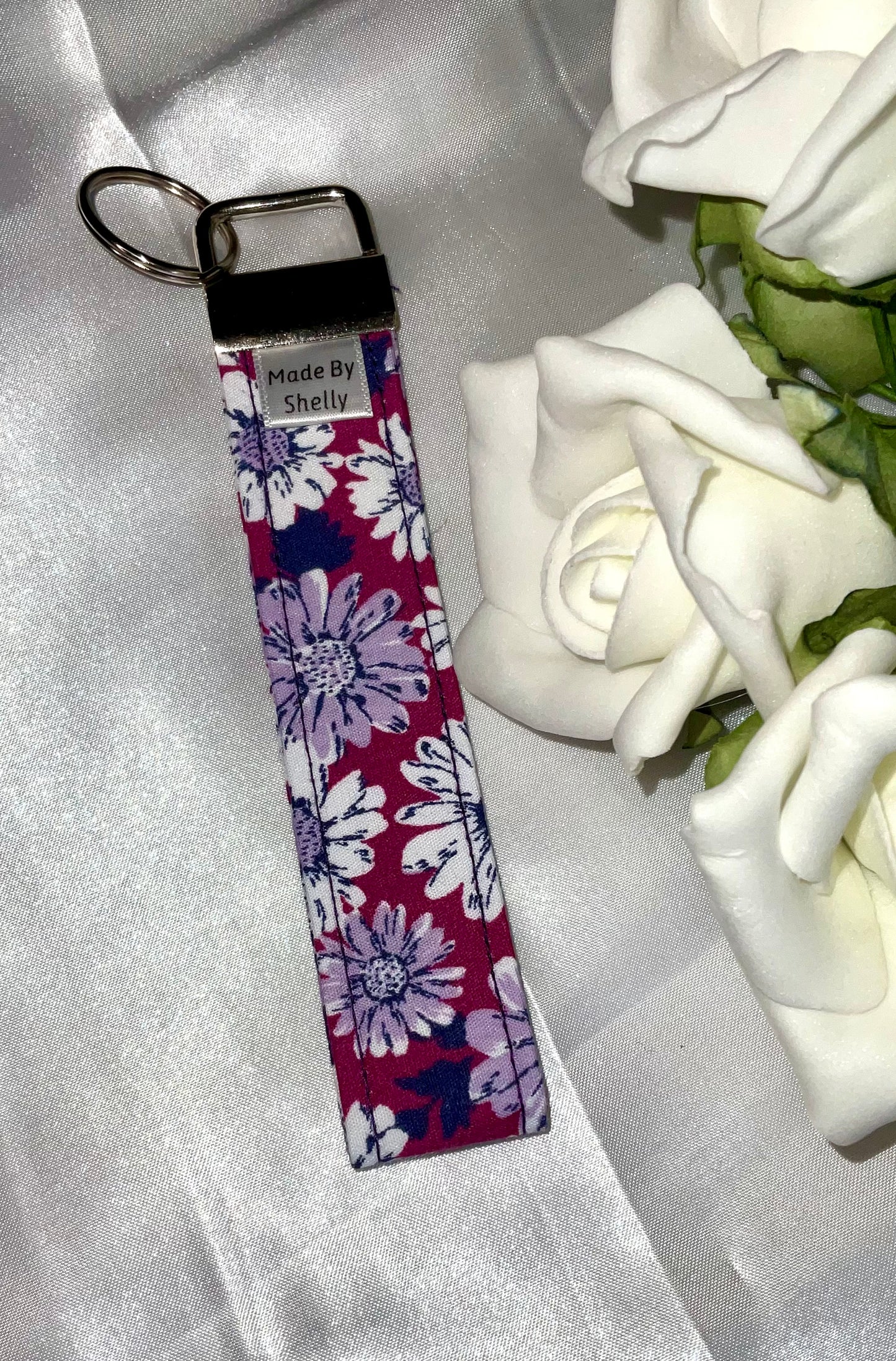 Daisy Wristlets With A Silver Tone Hardware
