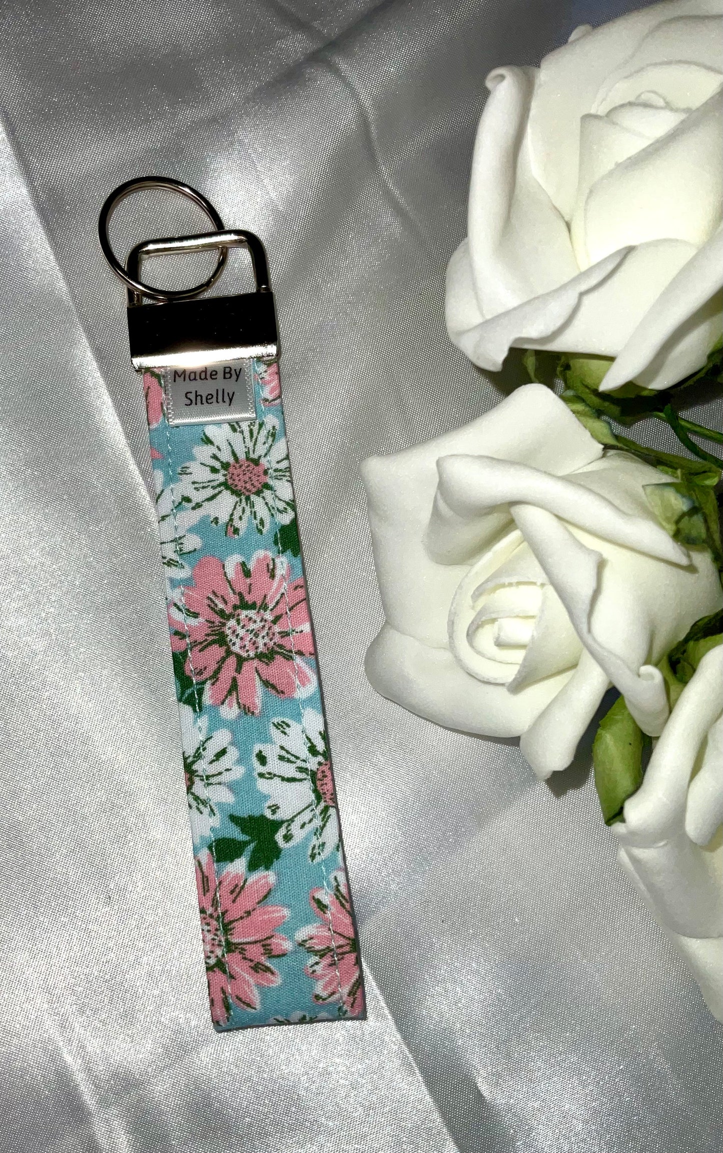 Daisy Wristlets With A Silver Tone Hardware