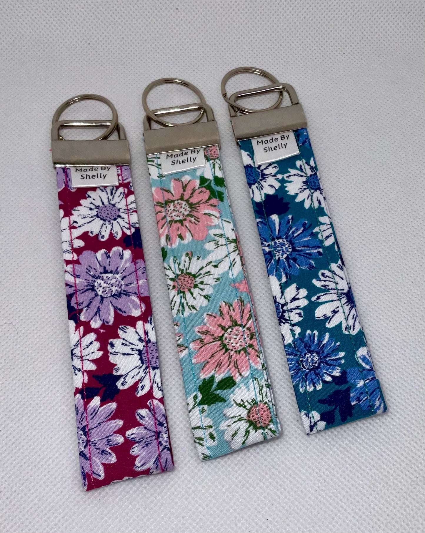 Daisy Wristlets With A Silver Tone Hardware