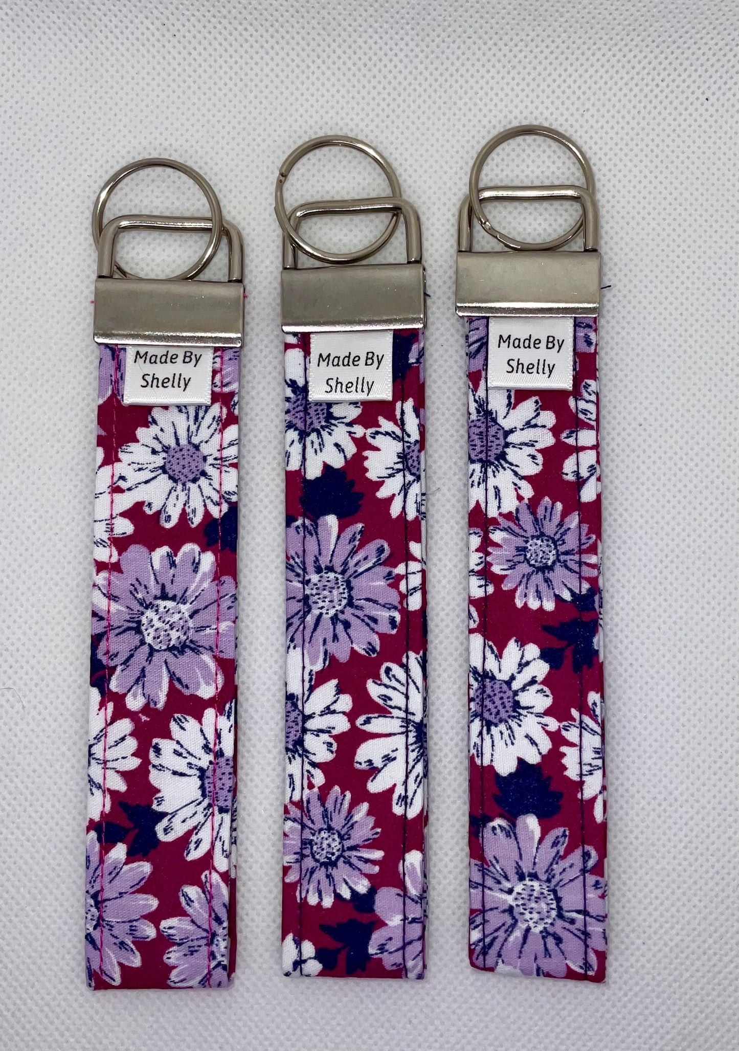 Daisy Wristlets With A Silver Tone Hardware