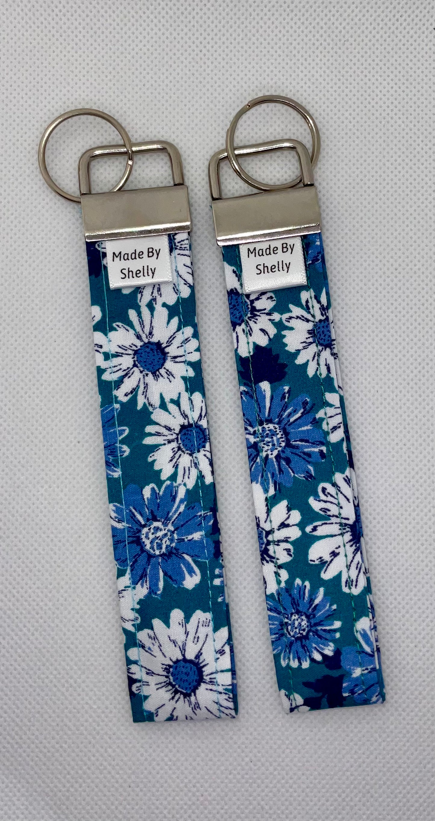 Daisy Wristlets With A Silver Tone Hardware