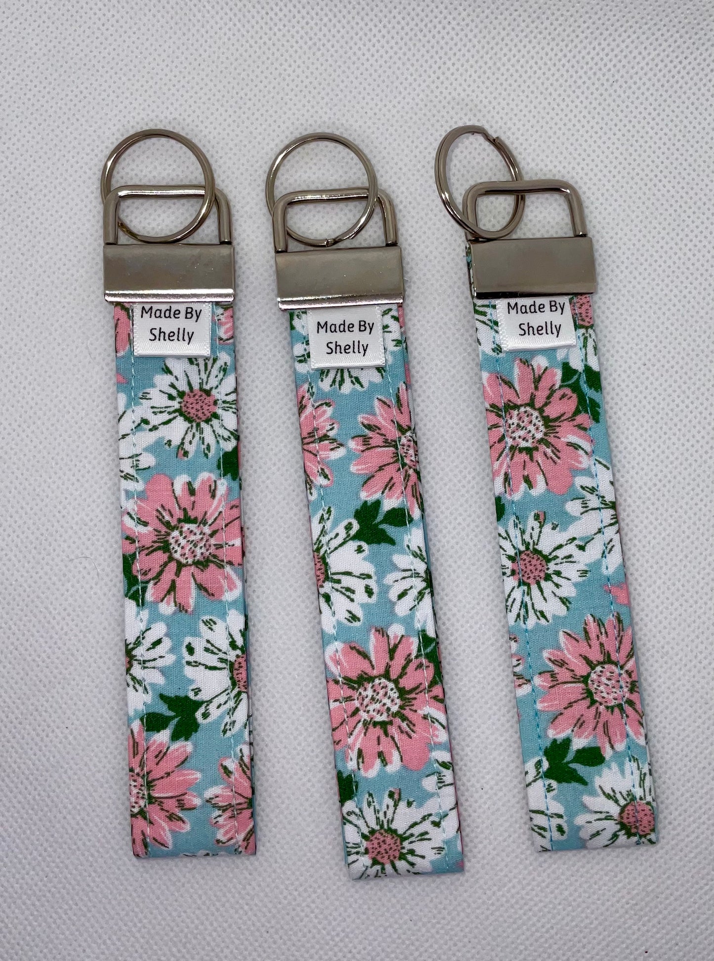 Daisy Wristlets With A Silver Tone Hardware